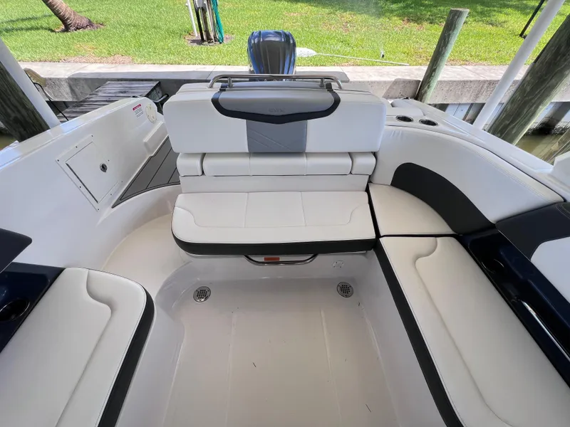 Slide: The Image of 2022 Chaparral 267 SSX OB boat interior with white seating and modern design. - 13