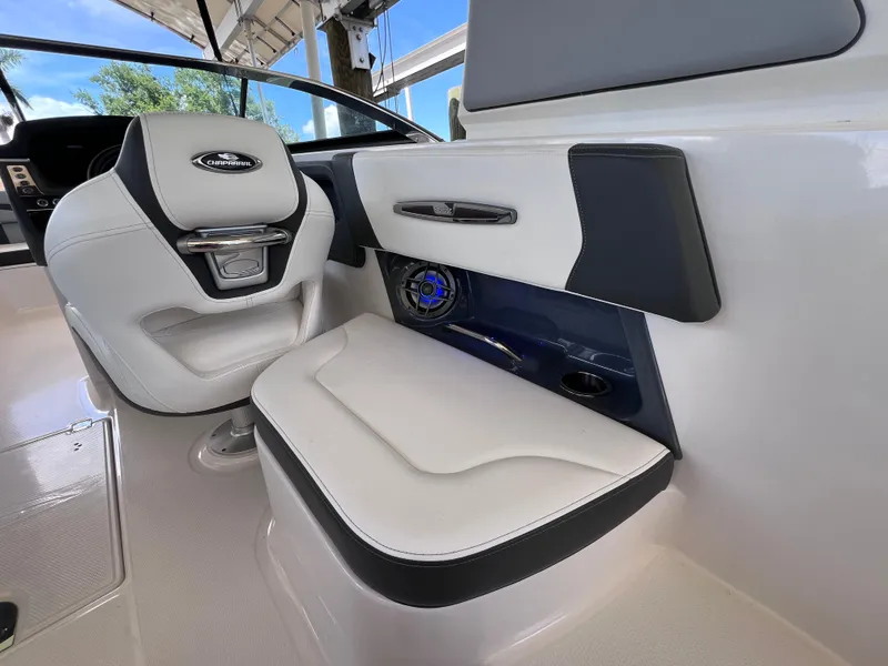 Slide: The Image of 2022 Chaparral 267 SSX OB boat interior with white seating and speaker system. - 15