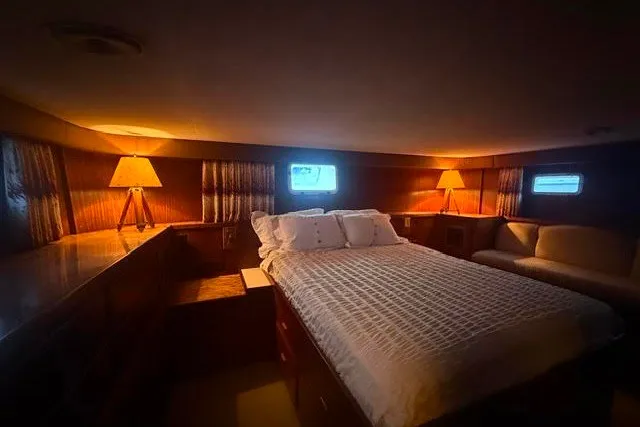 Slide: The Image of Luxurious bedroom interior of 1987 Hatteras 72 Motor Yacht with cozy lighting and elegant decor. - 9