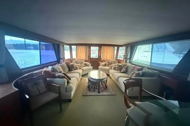 Slide: The Image of Luxurious interior of a 1987 Hatteras 72 Motor Yacht with elegant seating and panoramic windows. - 5