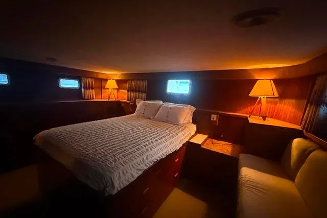 Slide: The Image of Luxurious bedroom interior of 1987 Hatteras 72 Motor Yacht with cozy lighting. - 10