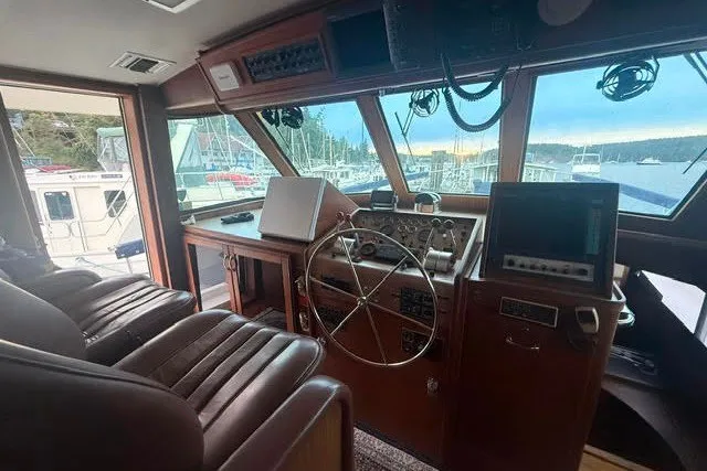 Slide: The Image of Interior helm of 1987 Hatteras 72 Motor Yacht with steering wheel and navigation equipment. - 7
