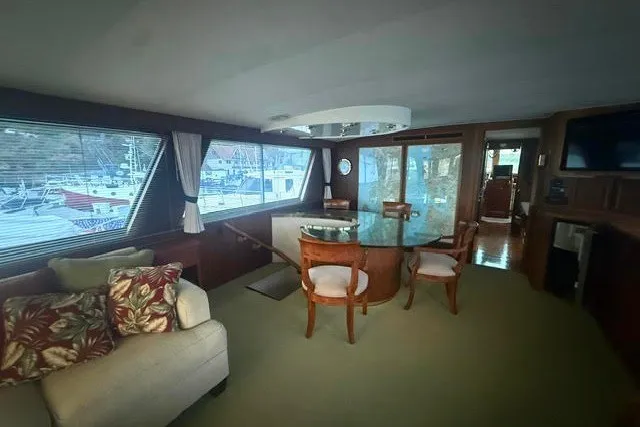 Slide: The Image of Luxurious interior of a 1987 Hatteras 72 Motor Yacht with elegant seating and large windows. - 6