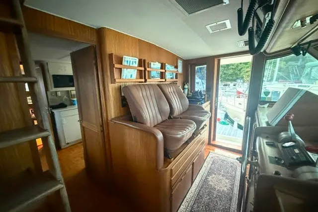 Slide: The Image of Interior of 1987 Hatteras 72 Motor Yacht with leather seating and wooden cabinetry. - 8