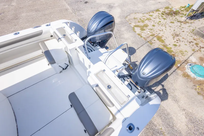 Slide: The Image of 2022 World Cat 325 CC boat with dual Yamaha engines, spacious seating, and fishing amenities. - 60