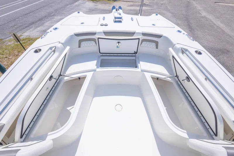Slide: The Image of 2022 World Cat 325 CC boat interior with open storage compartments and seating area. - 43