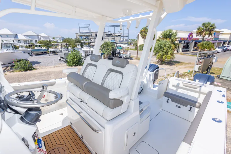 Slide: The Image of 2022 World Cat 325 CC boat interior with dual seating and steering wheel. - 51