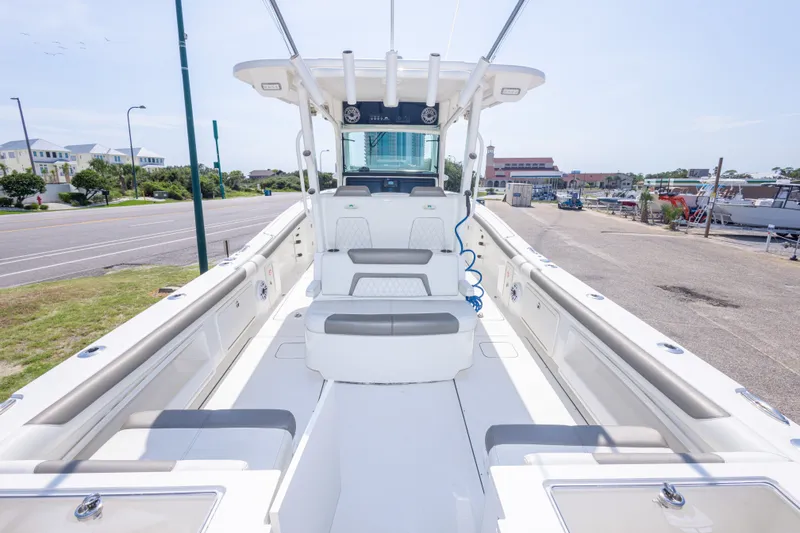 Slide: The Image of 2022 World Cat 325 CC boat interior with seating and helm station. - 23
