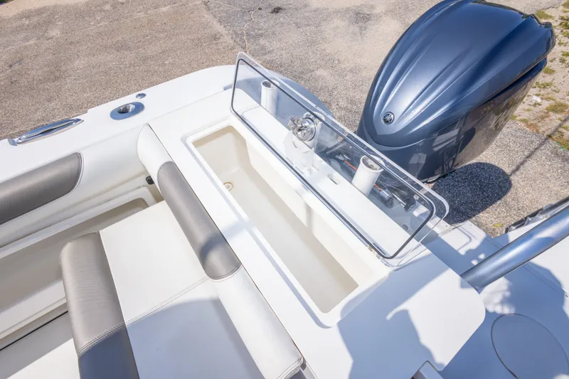 Slide: The Image of 2022 World Cat 325 CC boat with open storage compartment and outboard motor. - 62