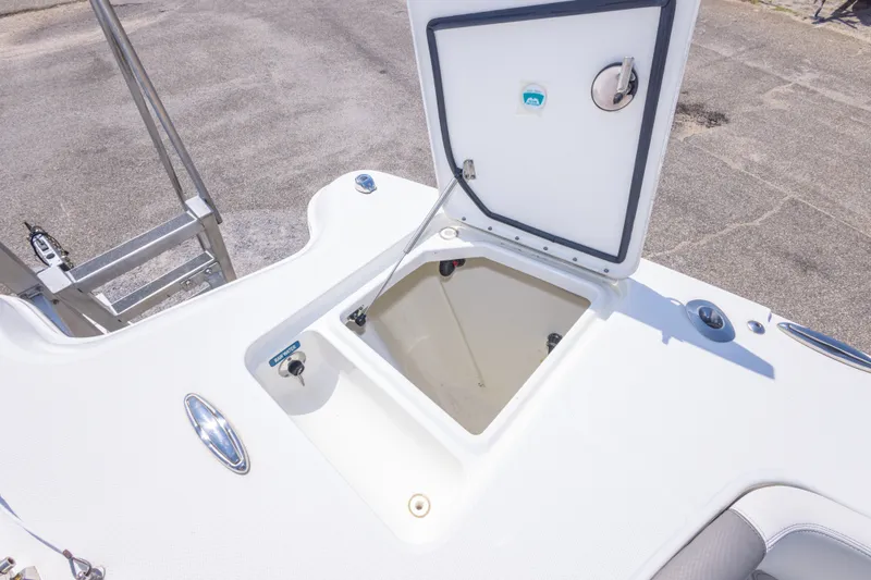 Slide: The Image of Open storage compartment on 2022 World Cat 325 CC boat deck. - 39
