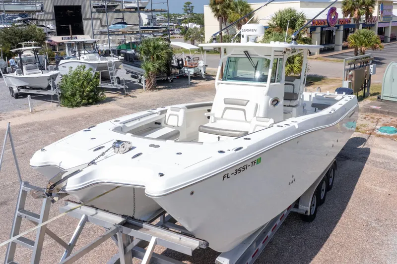 Slide: The Image of 2022 World Cat 325 CC boat on trailer, marina background, sunny day. - 4