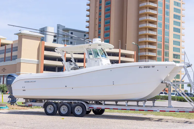 The Image of 2022 World Cat 325 CC boat on trailer, urban background, sunny day. - 0