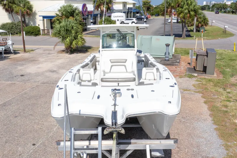 Slide: The Image of 2022 World Cat 325 CC boat on display, front view, outdoors. - 5