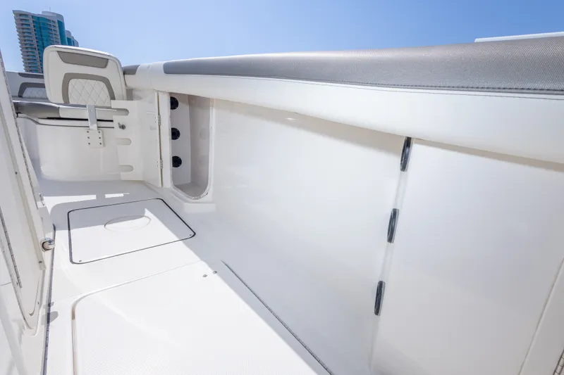 Slide: The Image of 2022 World Cat 325 CC boat interior with sleek white design and modern seating. - 49