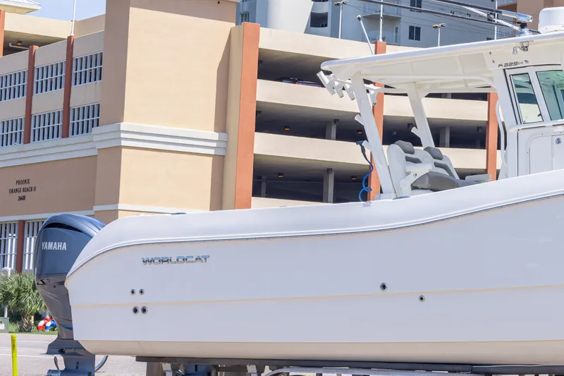 Slide: The Image of 2022 World Cat 325 CC boat with Yamaha engine, parked near a building. - 9