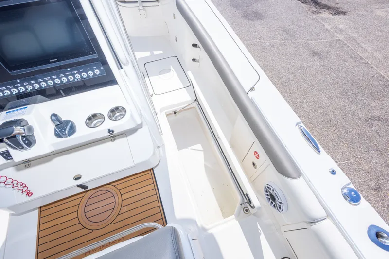 Slide: The Image of 2022 World Cat 325 CC boat interior with control panel and seating area. - 56