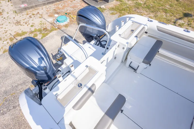 Slide: The Image of 2022 World Cat 325 CC boat with dual Yamaha engines, spacious deck, and seating area. - 59