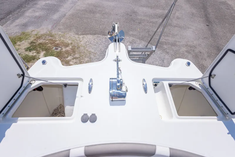Slide: The Image of 2022 World Cat 325 CC boat deck with open storage compartments and anchor. - 38