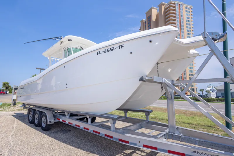 Slide: The Image of 2022 World Cat 325 CC boat on trailer, urban background, sunny day. - 11
