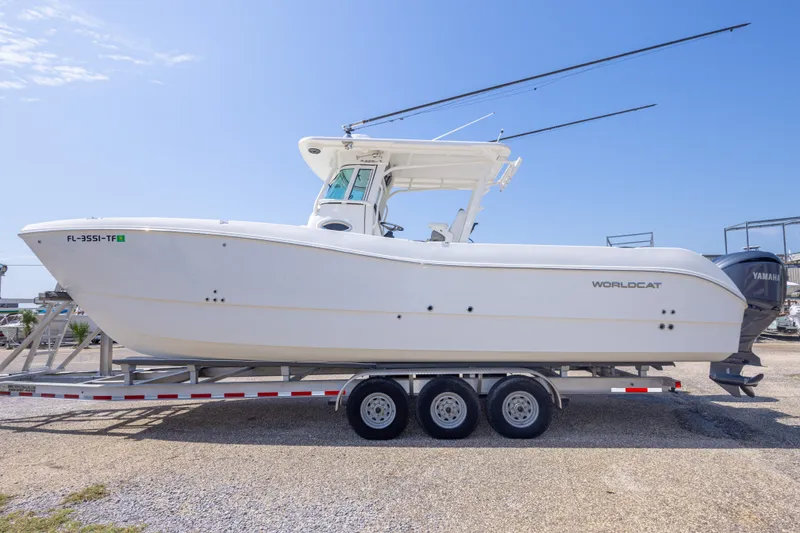 Slide: The Image of 2022 World Cat 325 CC boat on trailer, side view, clear sky background. - 19