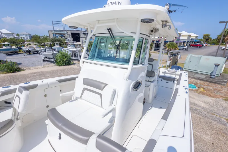 Slide: The Image of 2022 World Cat 325 CC boat with sleek design, docked in a marina setting. - 45