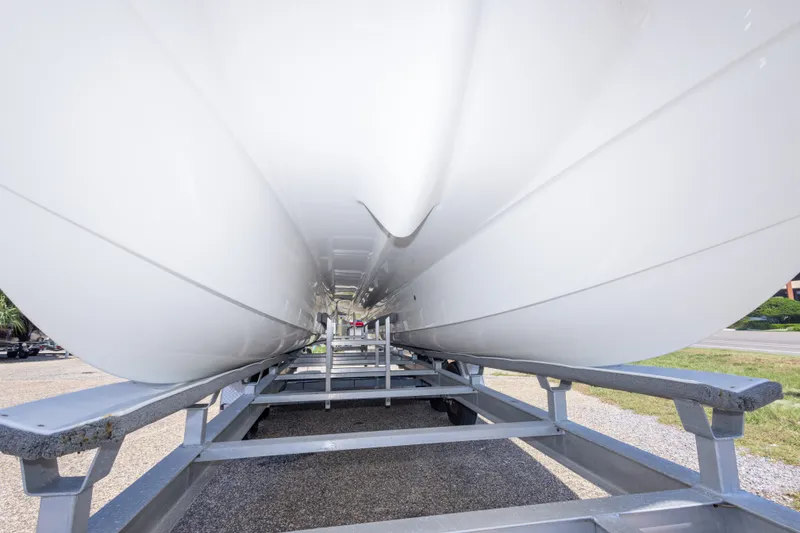 Slide: The Image of Underneath view of a 2022 World Cat 325 CC boat on a trailer. - 21