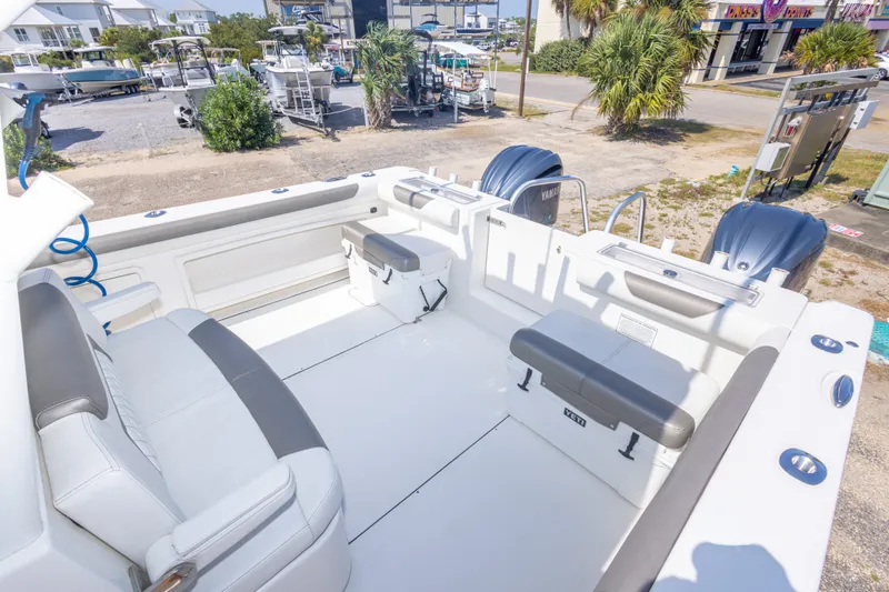 Slide: The Image of 2022 World Cat 325 CC boat interior with seating and dual engines. - 52
