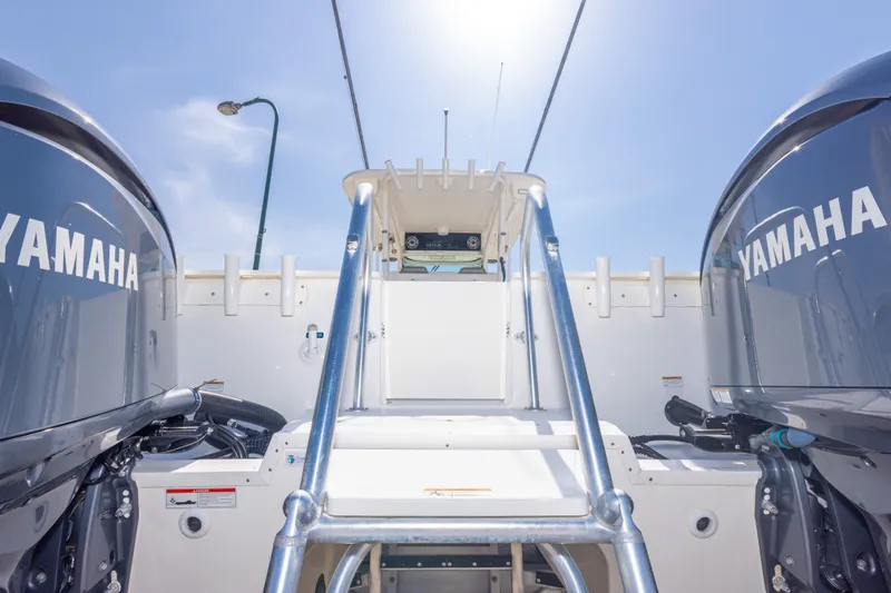 Slide: The Image of 2022 World Cat 325 CC boat with dual Yamaha engines under a clear sky. - 65