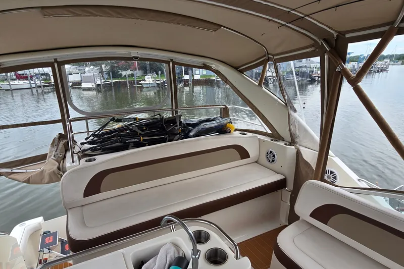 Slide: The Image of Interior view of a 2001 Silverton 330 Sport Bridge boat with seating and water backdrop. - 13