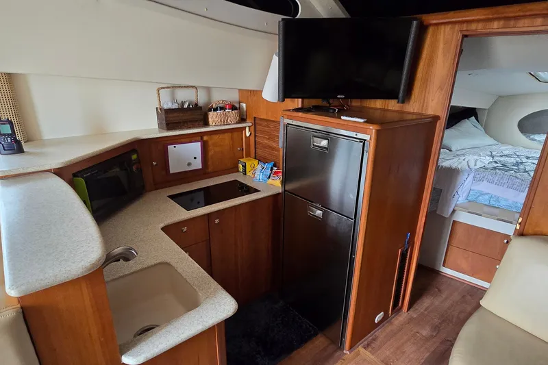 Slide: The Image of Interior of 2001 Silverton 330 Sport Bridge yacht with kitchenette and cozy sleeping area. - 20