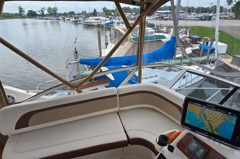 Slide: The Image of 2001 Silverton 330 Sport Bridge interior with marina view and navigation system. - 14