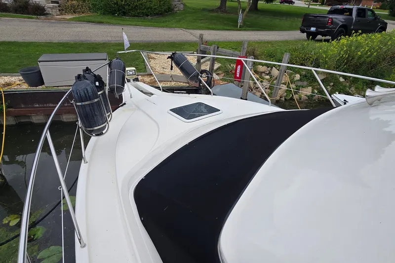 Slide: The Image of 2001 Silverton 330 Sport Bridge docked, featuring sleek design and deck equipment. - 15
