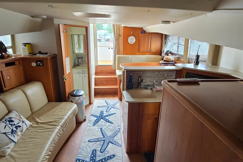 Slide: The Image of Interior of 2001 Silverton 330 Sport Bridge yacht with cozy seating and kitchenette. - 27