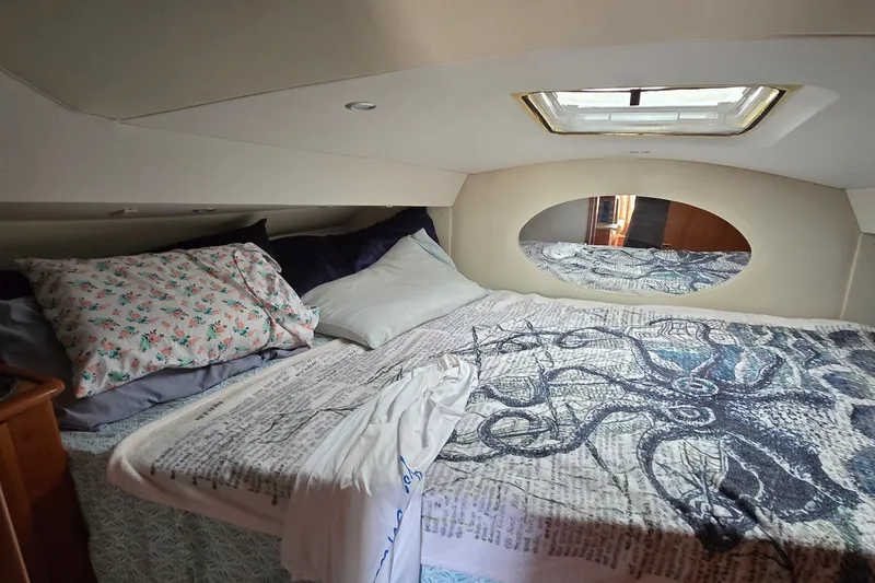 Slide: The Image of Cozy bedroom interior of 2001 Silverton 330 Sport Bridge yacht with skylight and mirror. - 24