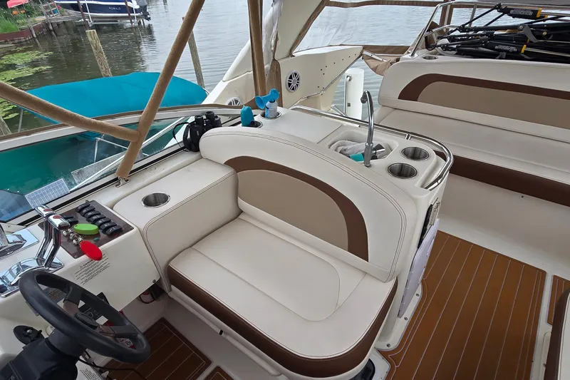 Slide: The Image of 2001 Silverton 330 Sport Bridge interior with seating, controls, and cup holders. - 12