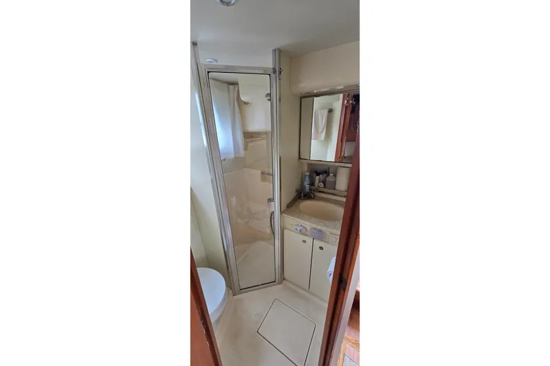Slide: The Image of Bathroom interior of 2001 Silverton 330 Sport Bridge yacht, featuring shower and sink. - 32