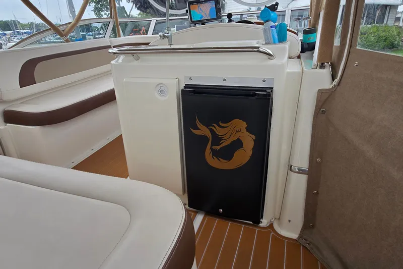 Slide: The Image of 2001 Silverton 330 Sport Bridge interior with mermaid design on fridge door. - 9