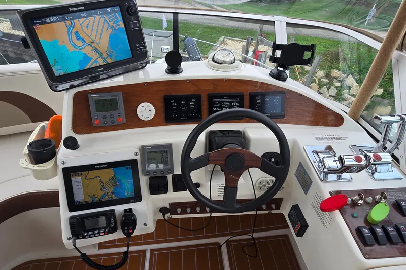 Slide: The Image of Cockpit of 2001 Silverton 330 Sport Bridge with navigation equipment and controls. - 11