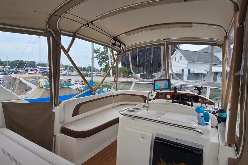 Slide: The Image of Interior view of a 2001 Silverton 330 Sport Bridge yacht with helm and seating area. - 8