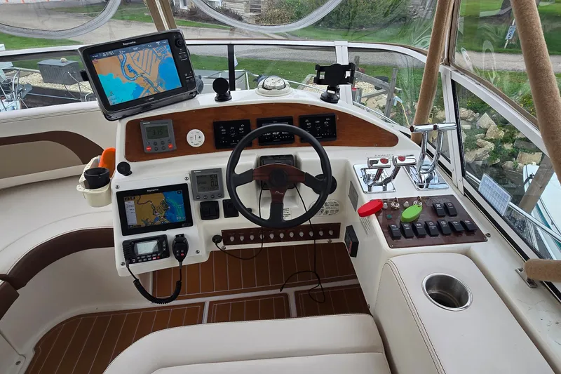 Slide: The Image of Cockpit of 2001 Silverton 330 Sport Bridge with navigation equipment and steering wheel. - 10