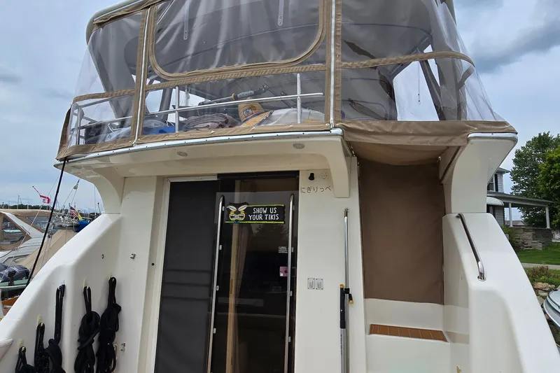 Slide: The Image of 2001 Silverton 330 Sport Bridge yacht with enclosed upper deck at marina. - 5