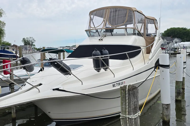 The Image of 2001 Silverton 330 Sport Bridge yacht docked at a marina. - 0