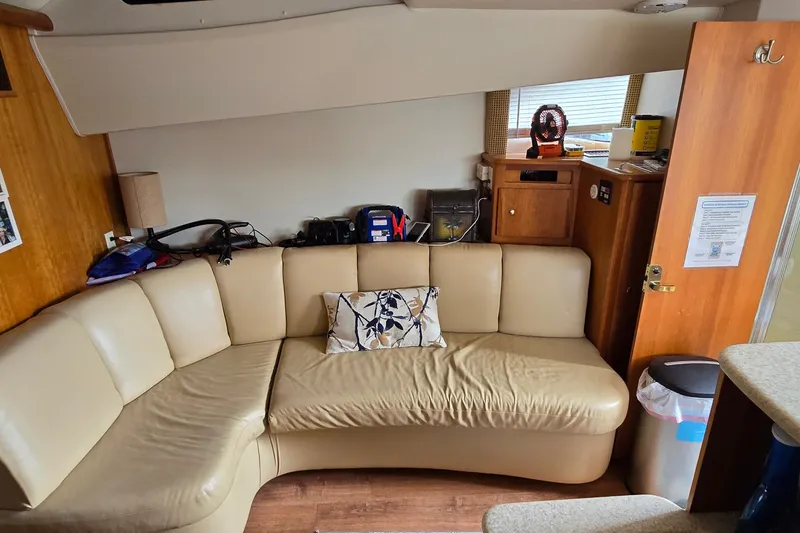 Slide: The Image of Interior of 2001 Silverton 330 Sport Bridge with beige leather seating and wooden accents. - 21