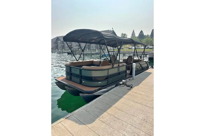 The Image of 2026 Bentley Pontoons Legacy 243 Swingback docked on a serene waterfront. - 0