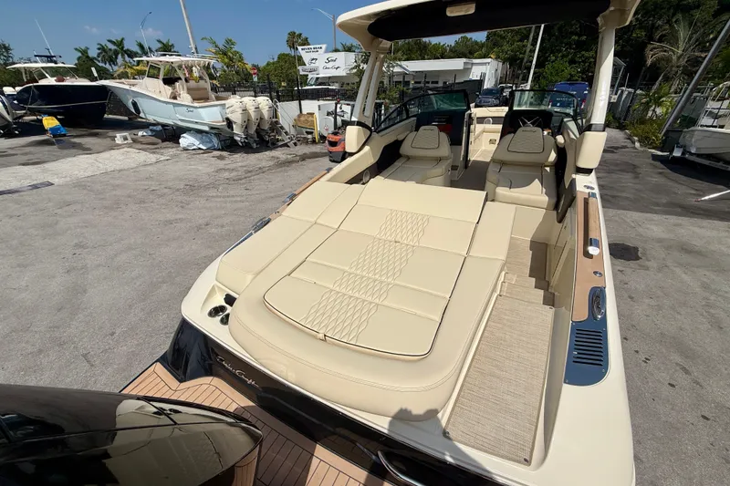 Slide: The Image of 2027 Chris-Craft Sportster 28 OB boat with luxurious beige seating, docked outdoors. - 20