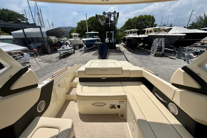 Slide: The Image of 2027 Chris-Craft Sportster 28 OB boat interior at a marina with other boats. - 14