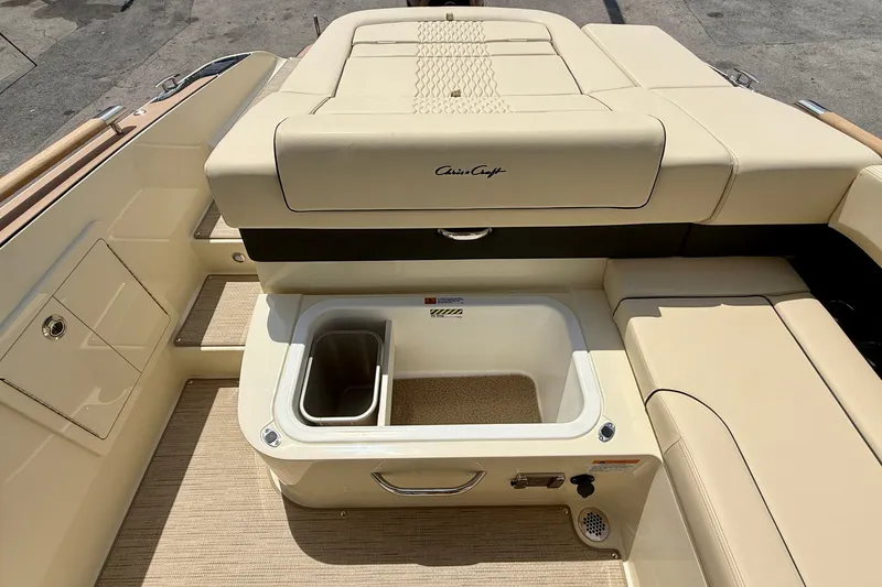 Slide: The Image of Luxurious 2027 Chris-Craft Sportster 28 OB boat interior with beige seating and storage compartment. - 21