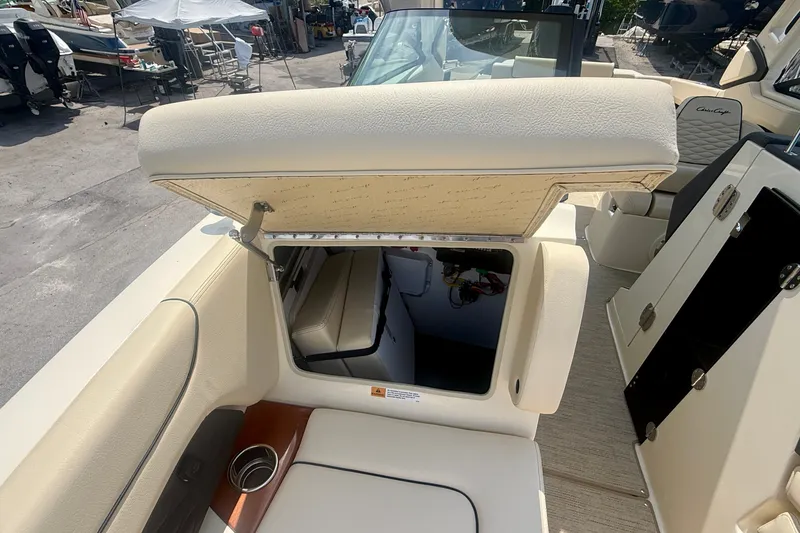 Slide: The Image of 2027 Chris-Craft Sportster 28 OB boat interior with open storage compartment and seating. - 25