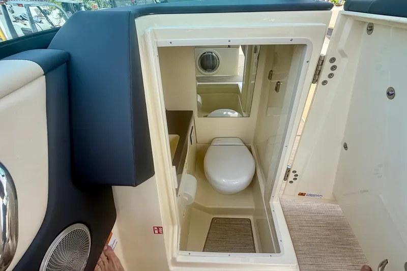 Slide: The Image of Interior view of 2027 Chris-Craft Sportster 28 OB boat bathroom with toilet and mirror. - 22