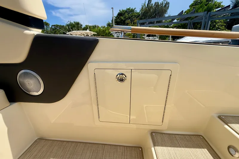 Slide: The Image of 2027 Chris-Craft Sportster 28 OB interior detail with speaker and storage compartment. - 18
